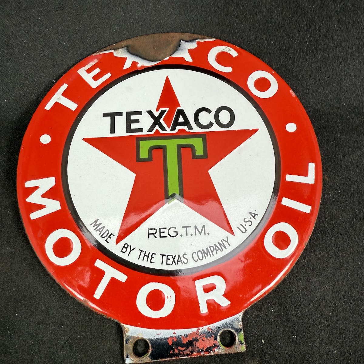 Small round double sided enamel sign. Texaco Motor Oil. Made by the Texas Company U. S. A. Green T with black outline on red star.