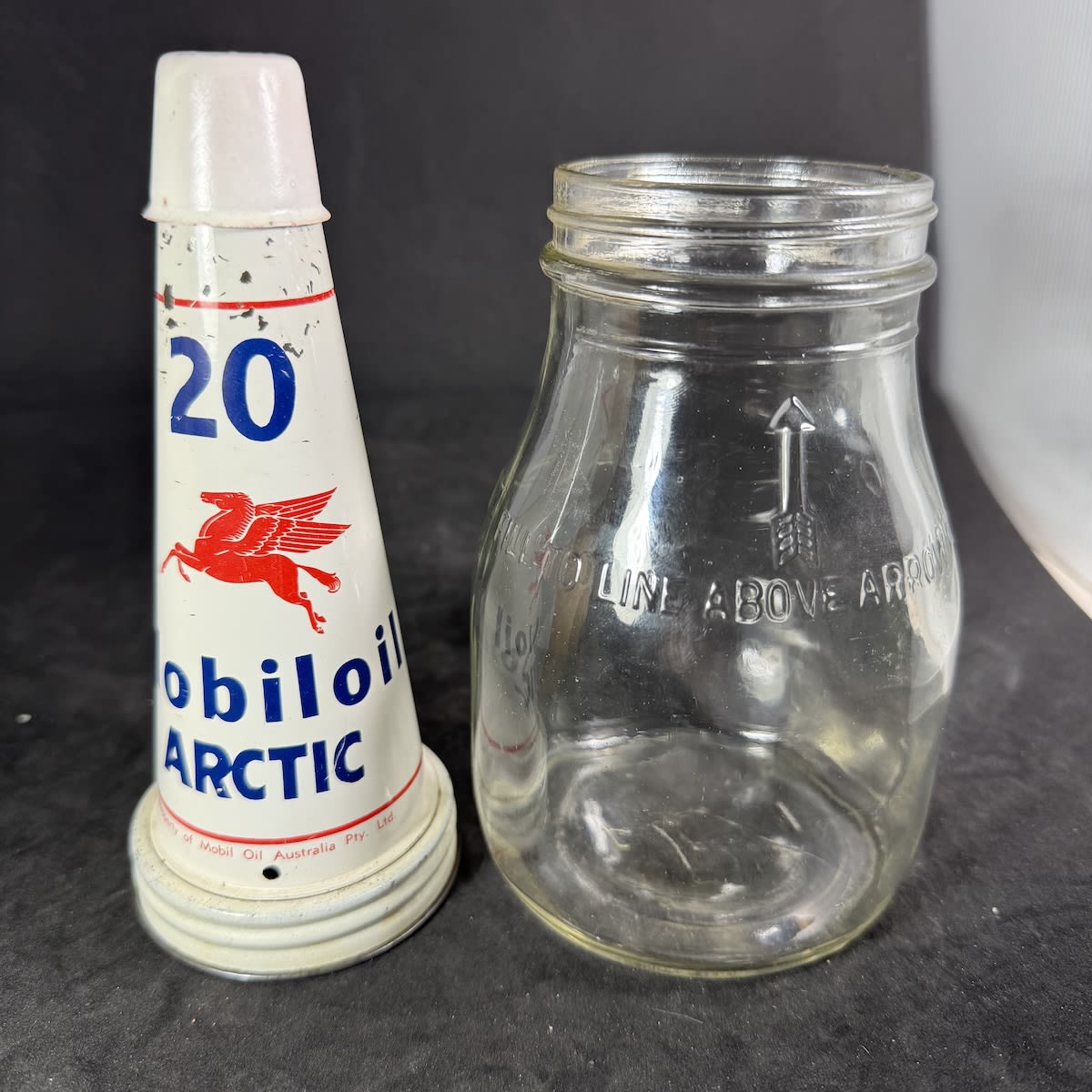 Pint Oil bottle with tin top pourer. Mobiloil Arctic. Pegasus facing left. Mobil Oil Australia Pty Ltd. Generic pint bottle.