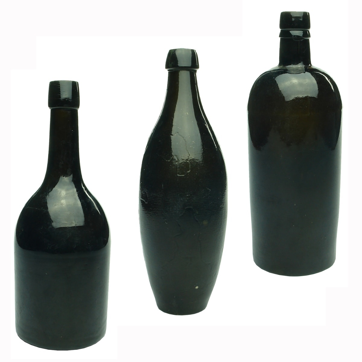 3 Black Glass Bottles: Unusual Liqueur shape with thick top and deep punt to base; large black skittle; Round three piece mould whisky with short neck.