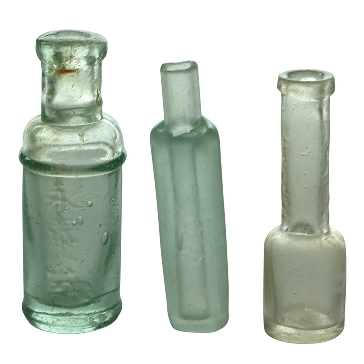 Chinese. Three little bottles: 1. Small aqua bottle with two lines of characters on opposite side. 2. Aqua "opium" bottle. 3. Small clear bottle with very long neck with characters down each side of neck. (China)