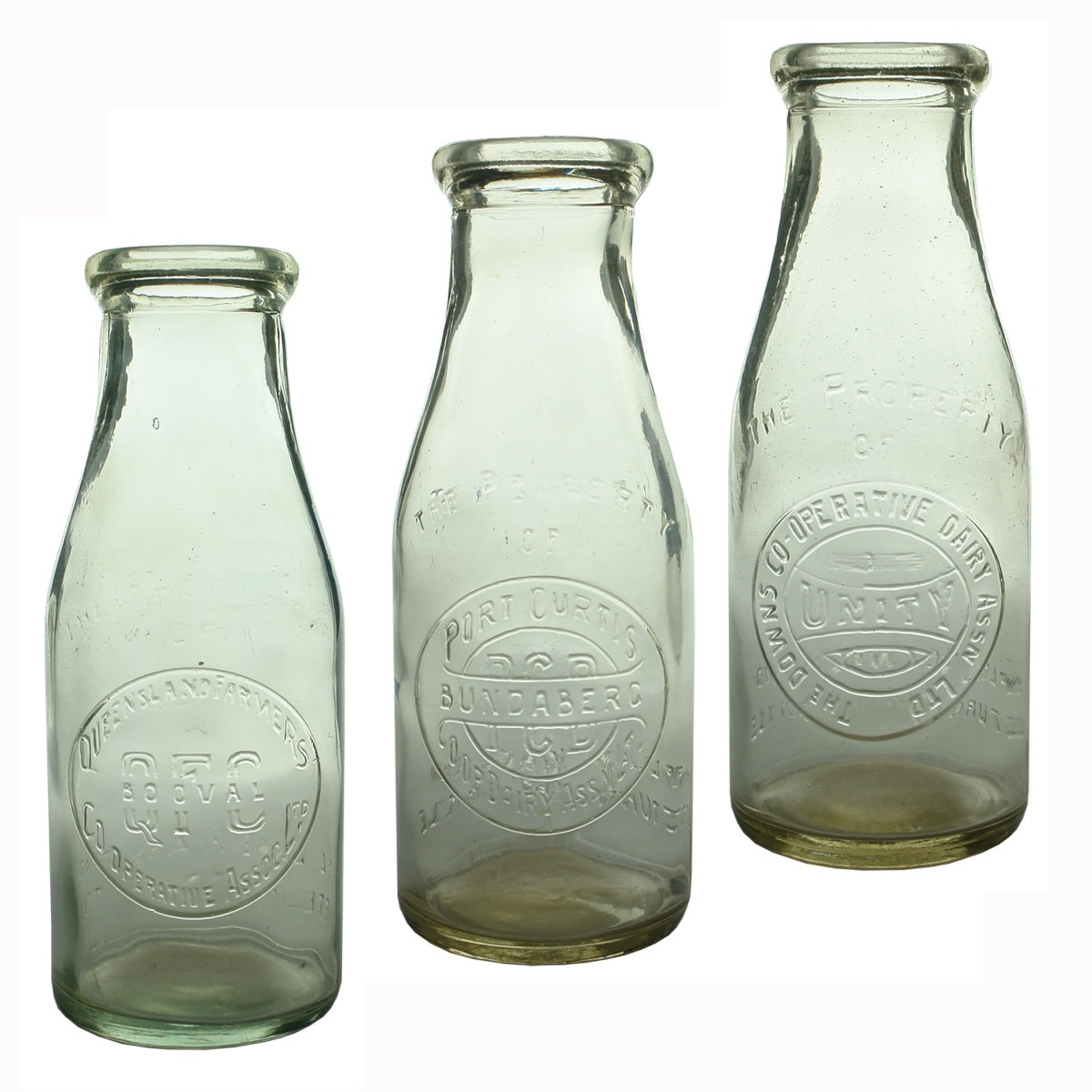 3 Milk Bottles: Queensland Farmers Co-operative Assoc Ltd Booval; Port Curtis Co-op Dairy Assn Ltd Bundaberg; The Downs Co-operative Dairy Assn Ltd Unity. Pints. (Queensland)