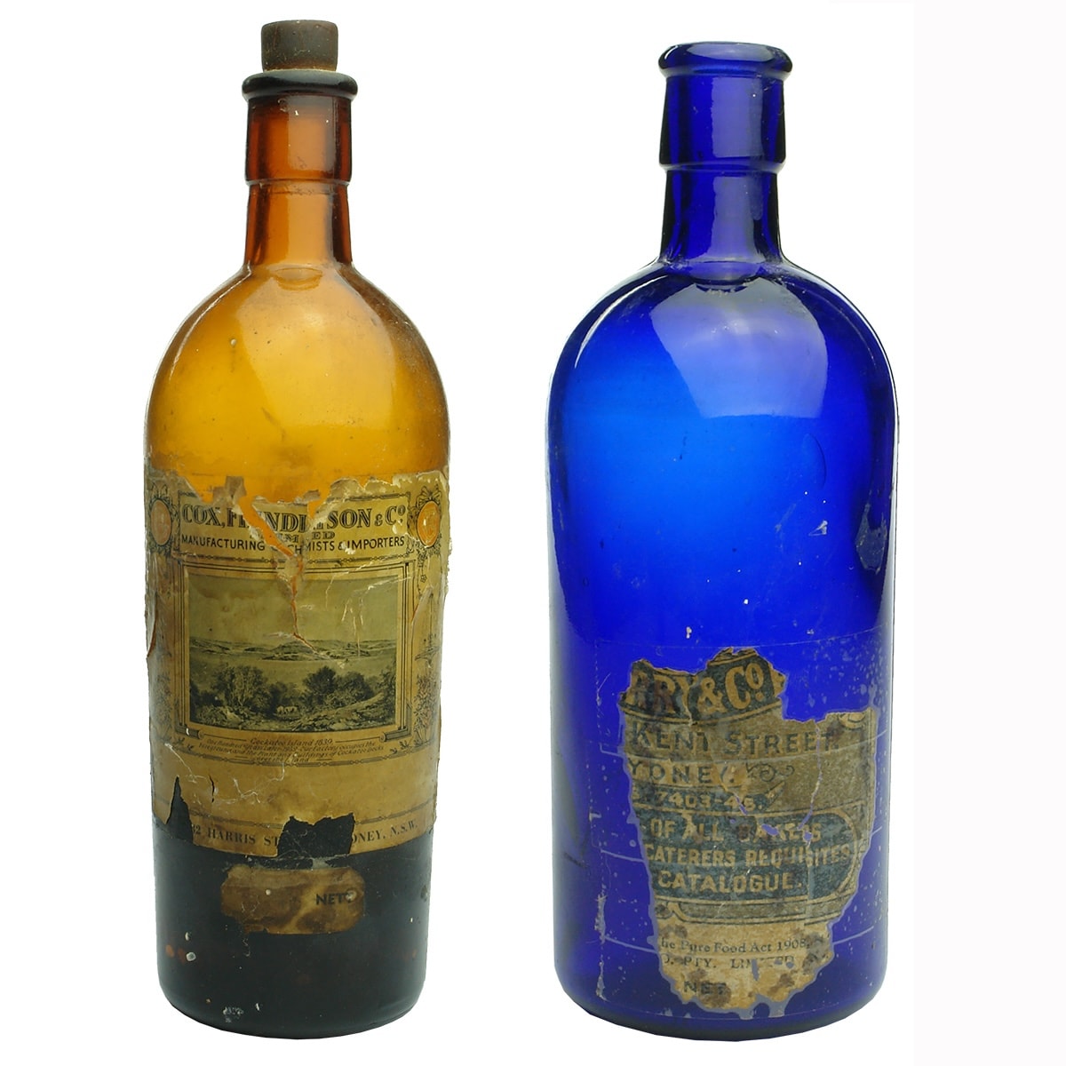 2 Labelled Essence Bottles: Amber - Cox Findlayson & Co Sydney. Picture of Cockatoo Island on the label; Blue - Parry & Co? Henry Berry & Co? Also Sydney. (New South Wales)