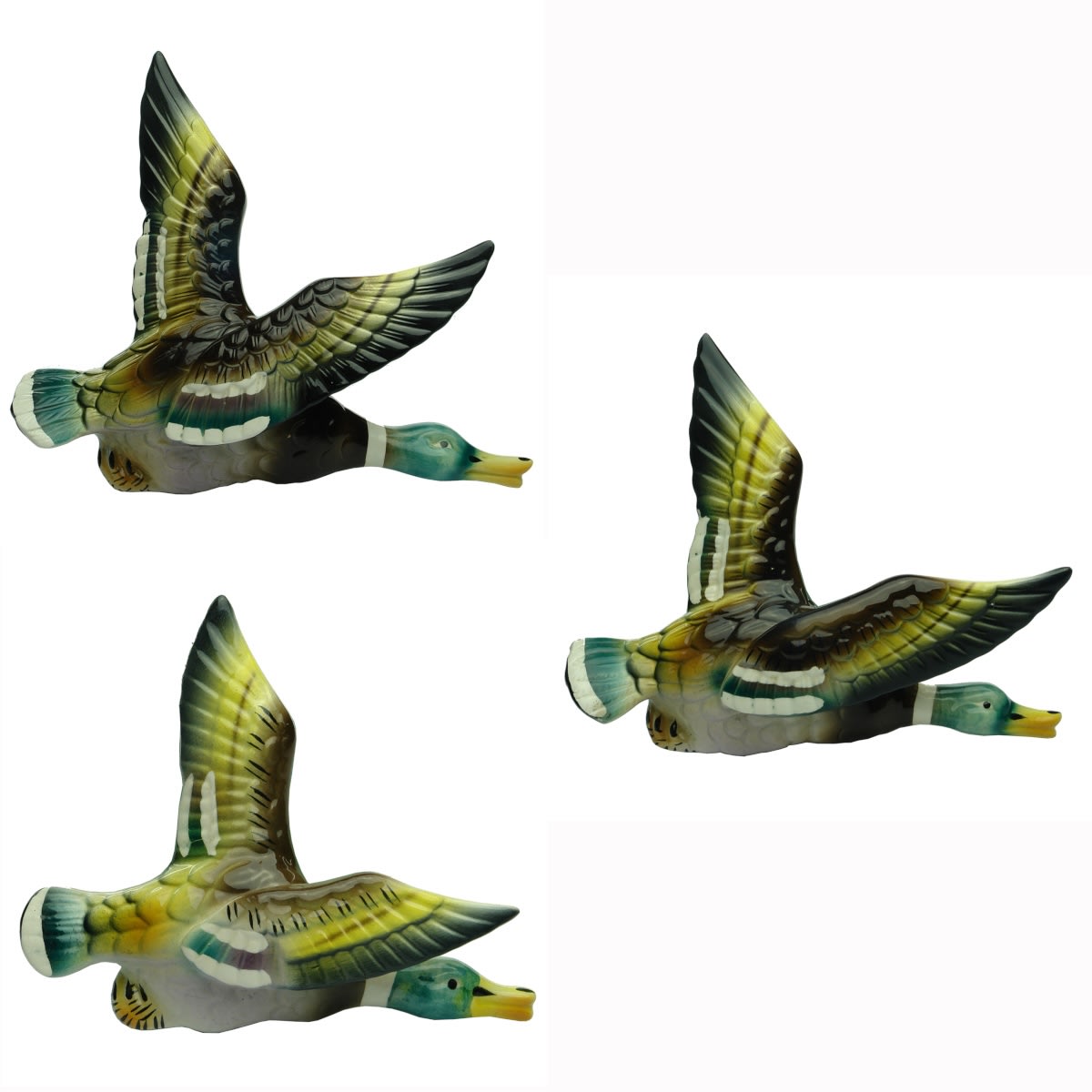 Set of 3 ceramic flying ducks wall decorations. Multi coloured. No makers marks.