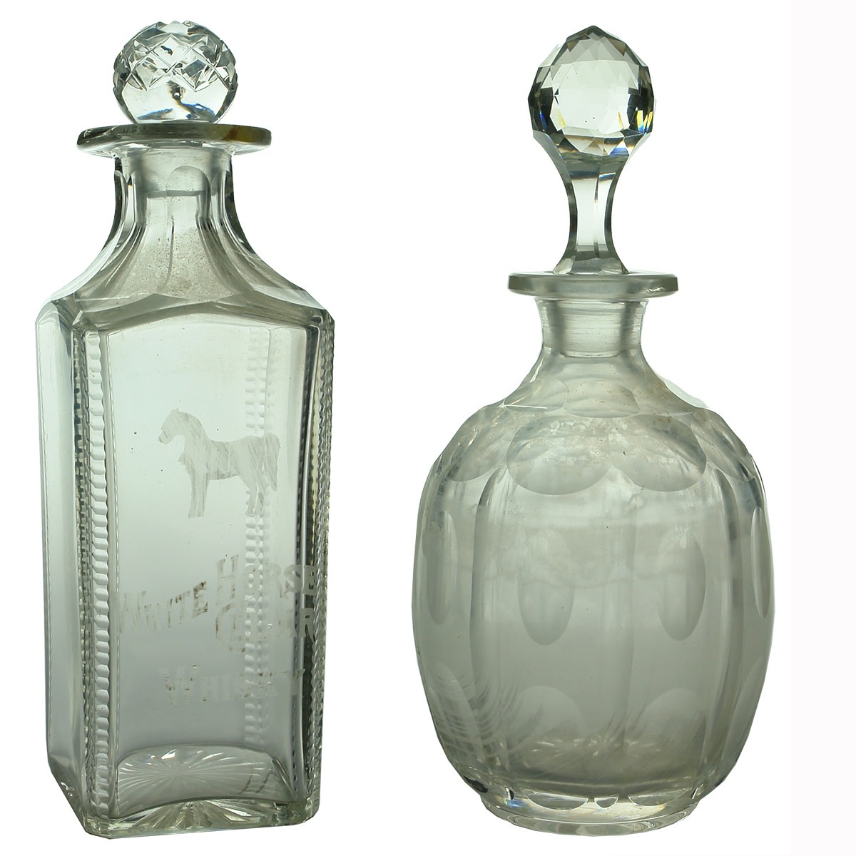 2 Glass Decanters. White Horse Cellar Whisky; Round moulded glass with stopper.