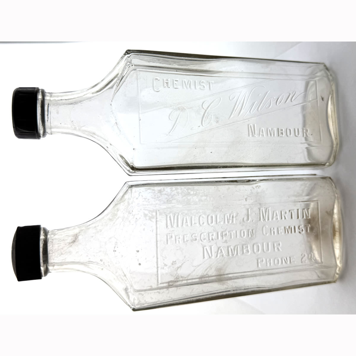 2 Screw top Chemists from Nambour. Malcolm J. Martin, Prescription Chemist D. C. Wilson. Clear. 8 oz. 181 - 183 mm with caps. (Queensland)