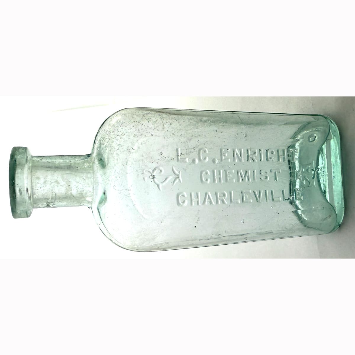 Chemist. L. C. Enright, Charleville. Unusual Melbourne Glass Works made strap sided bottle. 4 oz. 132 mm. (Queensland)