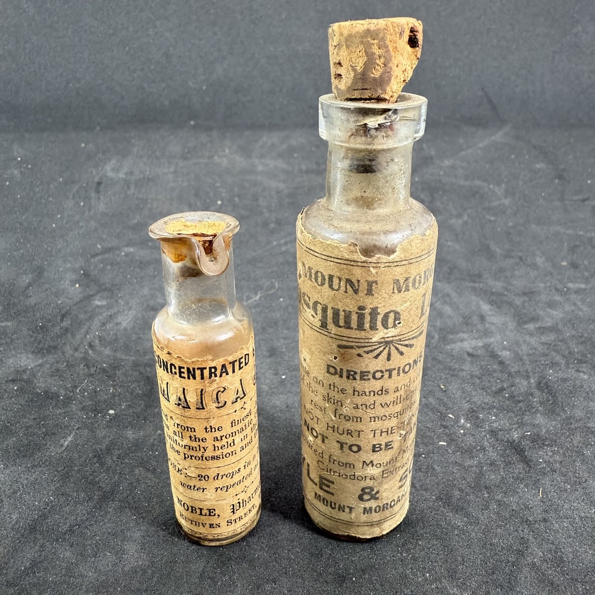 2 Labelled Chemist Vials: Mount Morgan Mosquito Lotion, Kyle & Sons, Mount Morgan Concentrated Essence of Jamaica Ginger, W. A. Noble, Chemist, Toowoomba. (Queensland)