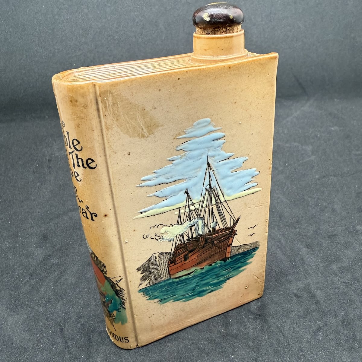 Book Shaped Stoneware Whisky. A Ramble Round the Globe. T. R. Dewar. Chatto & Windus. Doulton Lambeth. Multi-coloured on Salt Glaze.