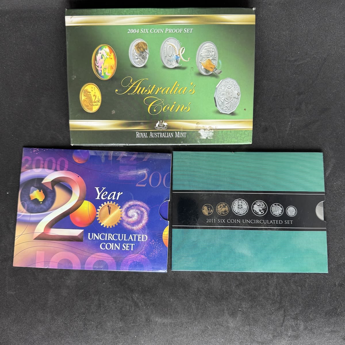 3 Australian Coin Sets. 2004 Proof Set 2000 Uncirculated Set 2011 Uncirculated Set. All in original packaging.
