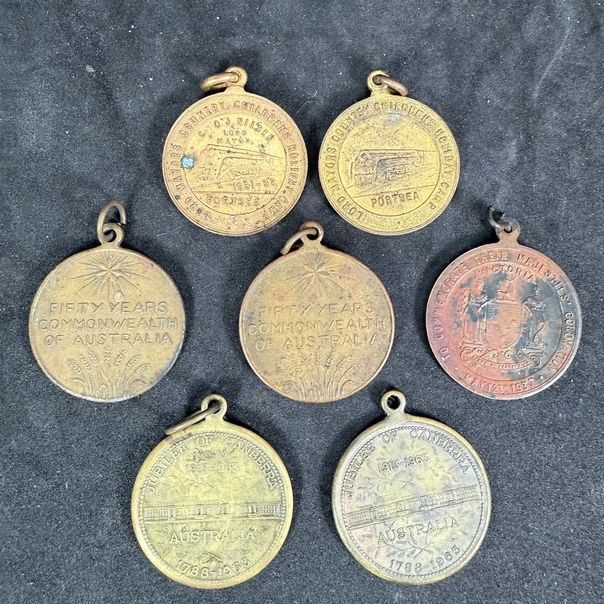 7 Medals/Medallions. 2 x City of Melbourne, Lord Mayors Childrens Holiday Portsea 2 x Jubilee of Canberra 2 x 50 Years Commonwealth of Australia 1937 Coronation.