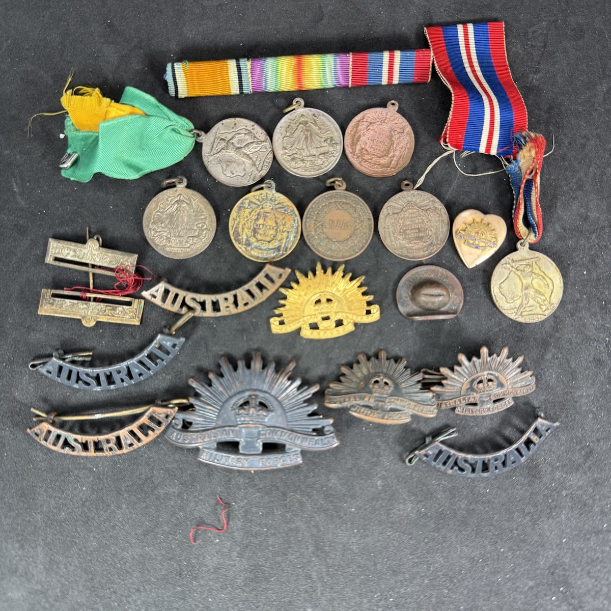 20 odd military and war related badges, medals, medallions, ribbons etc.