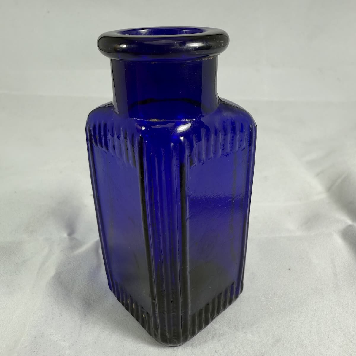 Poison. Triangular. Labels spaces and vertical lines around panels and down edges. Rd No 469164 on base. Burroughs Wellcome. Cobalt Blue. 1.5 oz. 94 mm.