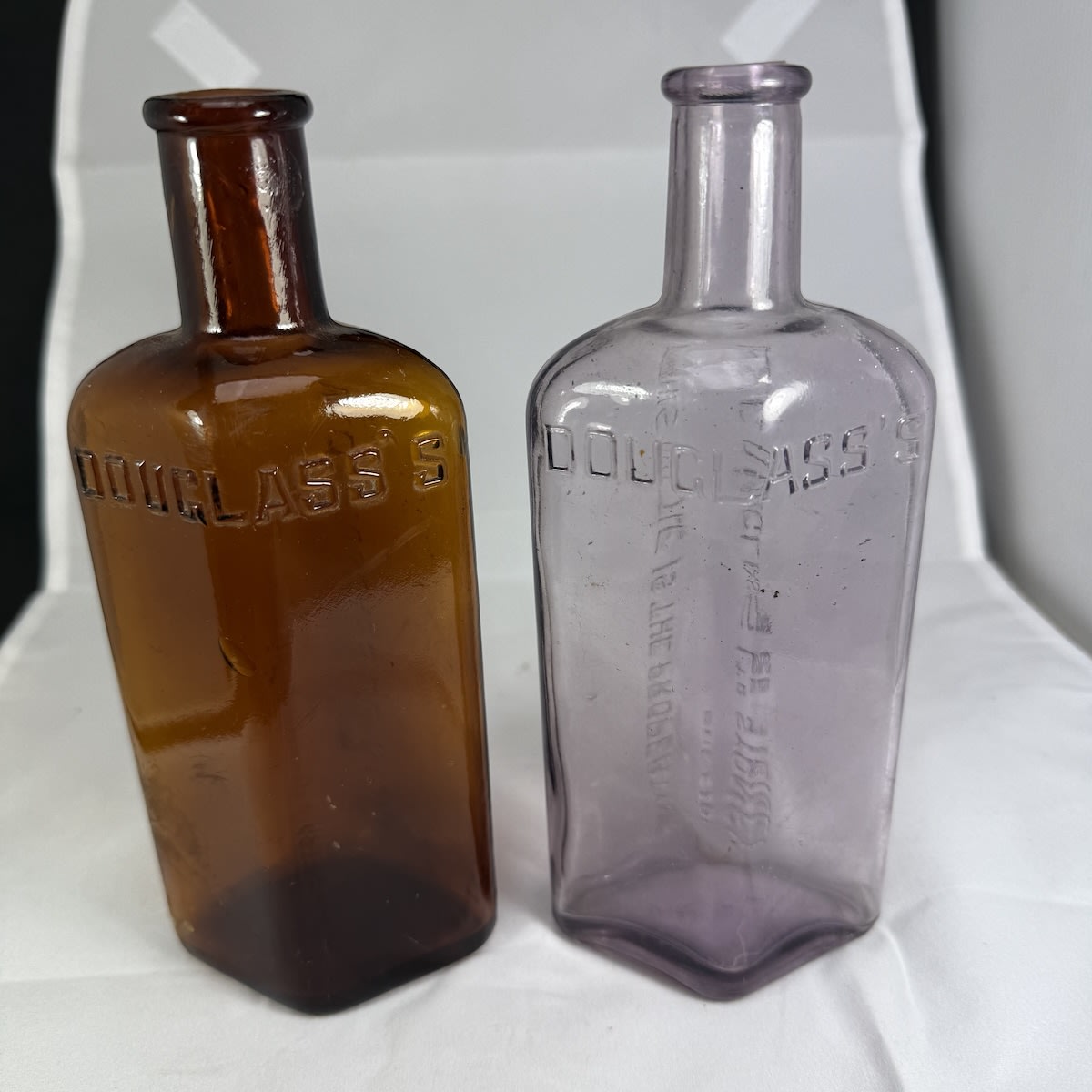 2 Phenyles/Disinfectants. Douglass's. W. C. Douglass Ltd Sydney. Amber & Amethyst. 10 oz. (New South Wales)
