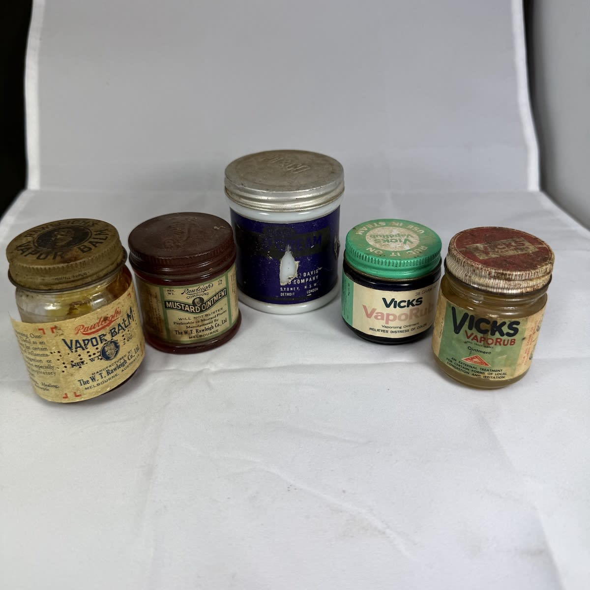 5 small labelled jars: 2 x Vicks Vaporub Rawleigh's Vapor Balm Rawleigh's Mustard Ointment Parke Davis Cold Cream.
