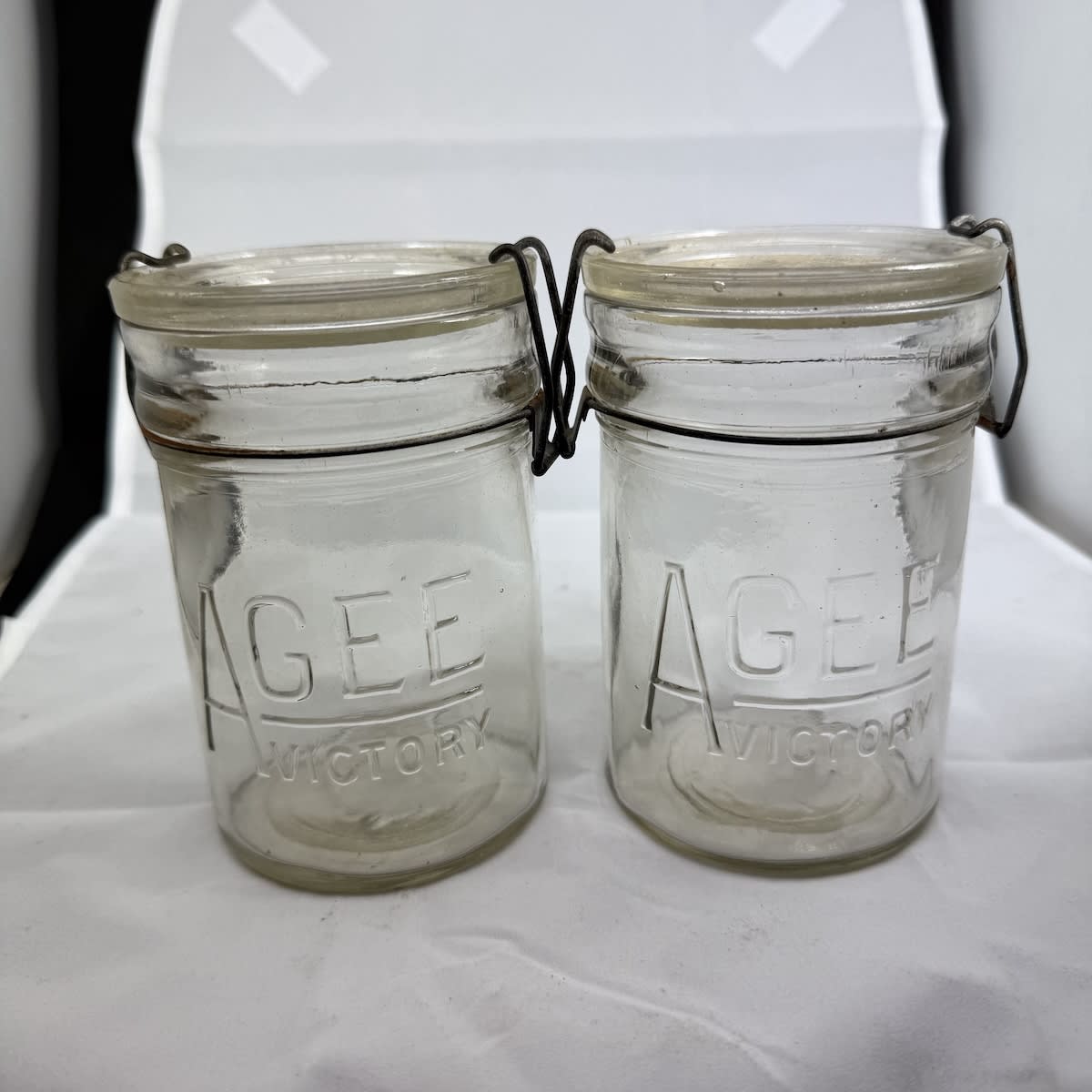 2 Preserving Jars. Pint sized Agee Victory jars with lids and clips.