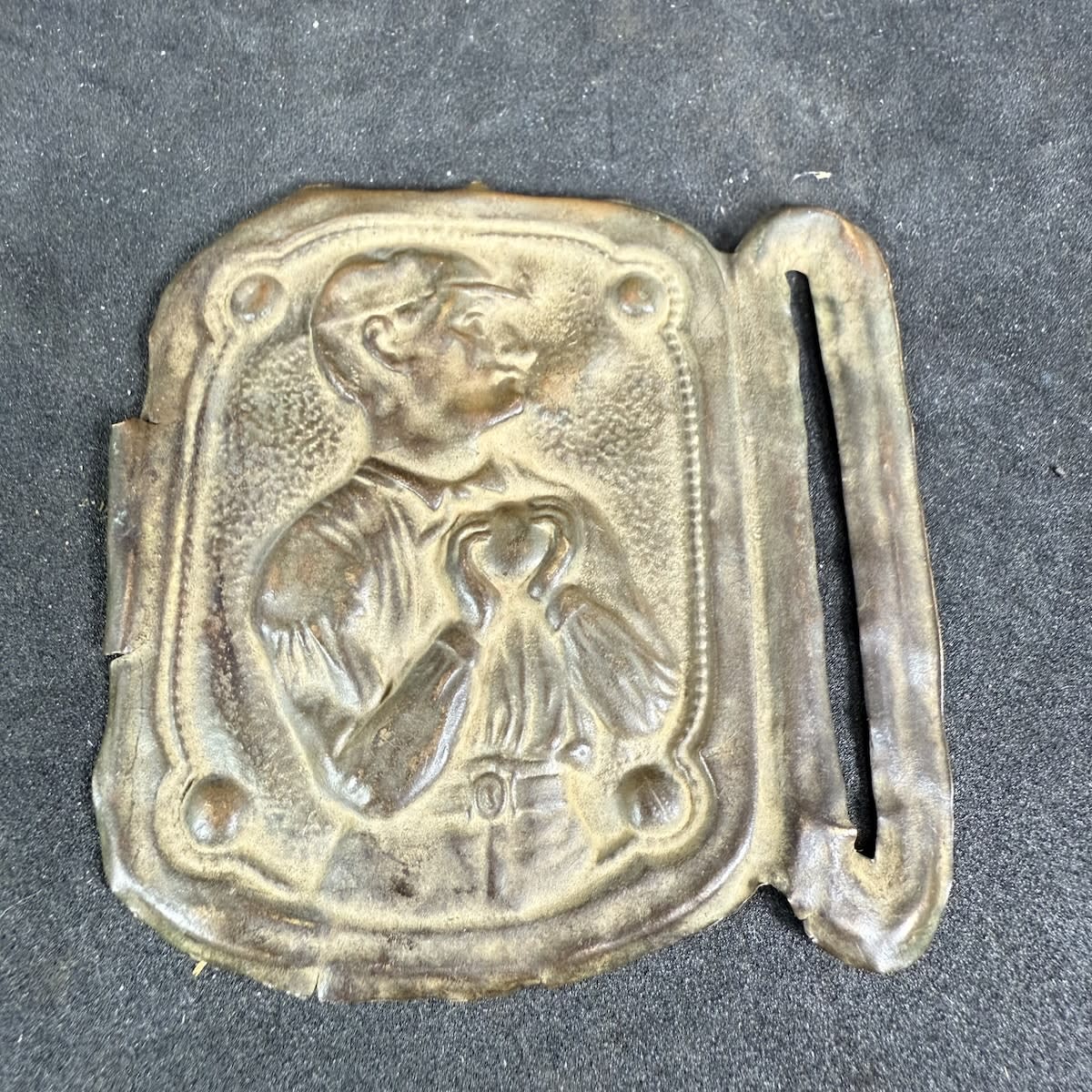 Cricket Belt Sash Buckle. Portrait of a Cricketer holding a ball in two hands in front of his chest.