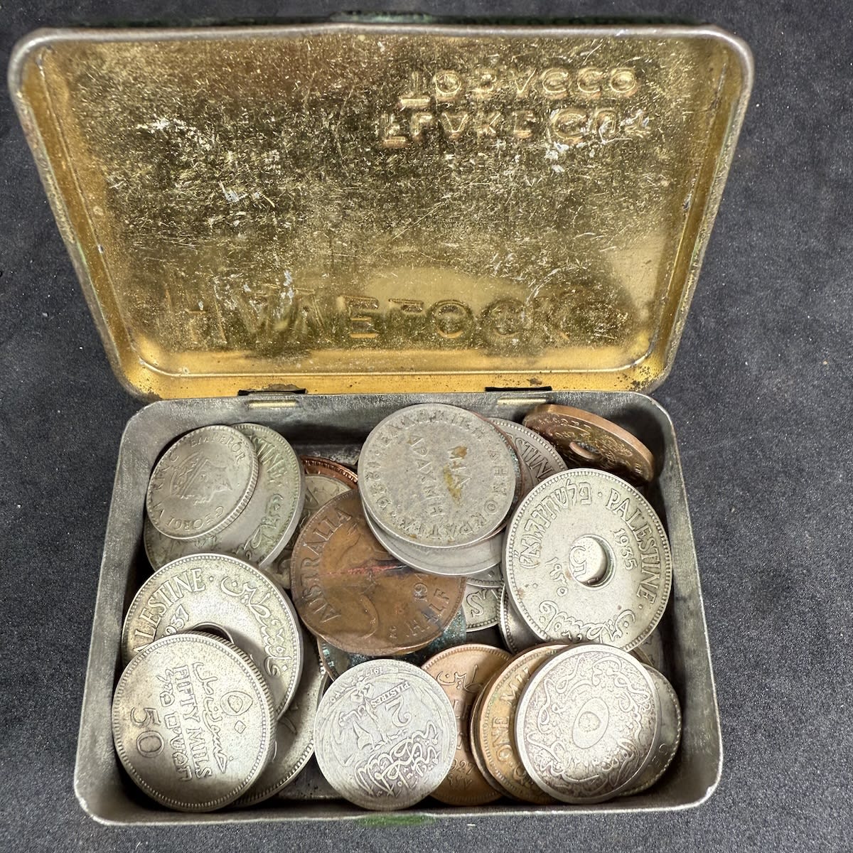 48 Coins in a Havelock Tobacco Tin. India, Palestine, France, Egypt, Greece, Ceylon, Australia. Collected by a soldier on duty in World War two. Coins date 1910s-  1940s.