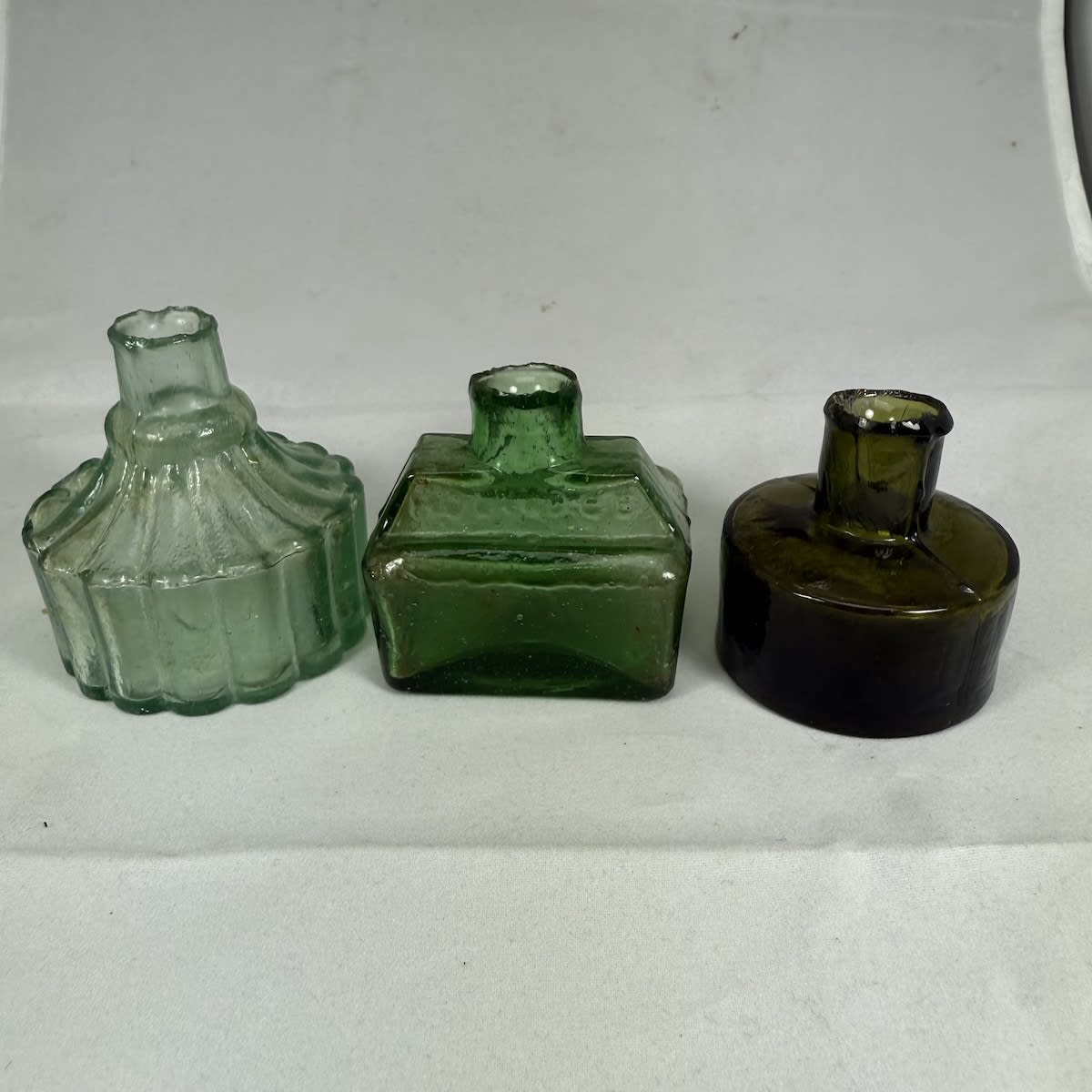 3 Glass Inks: Tent shape with British Registration Diamond on base Green Boat Ink, Hollidge on shoulder Small Dark Green round ink.