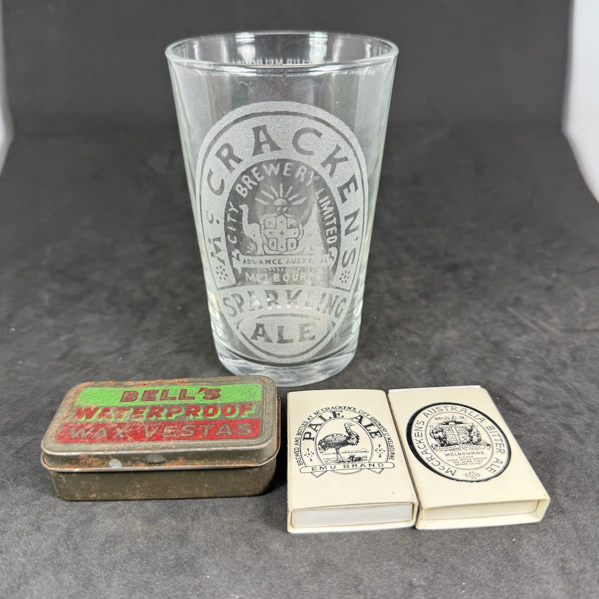 4 Items: Etched McCrackens Sparkling Ale glass Matchboxes with old McCrackens trade marks Bells Waterproof Vestas tin.