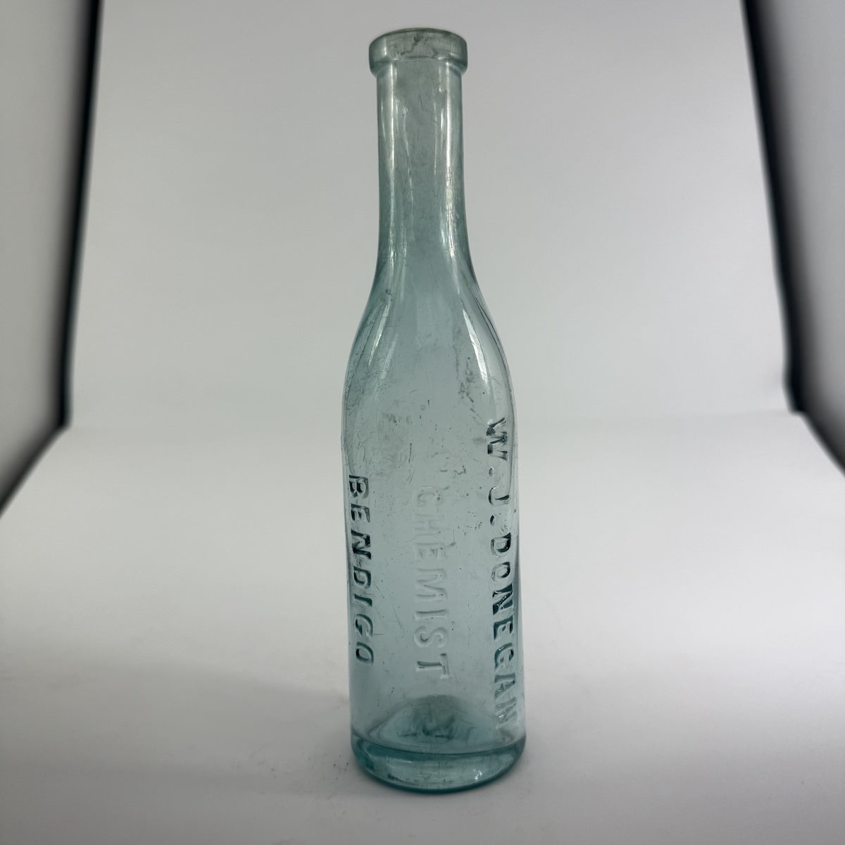 Chemist. W. J. Donegan, Bendigo. Little round almost Tomato sauce shape. Aqua. 4 oz. 174 mm. (Victoria)