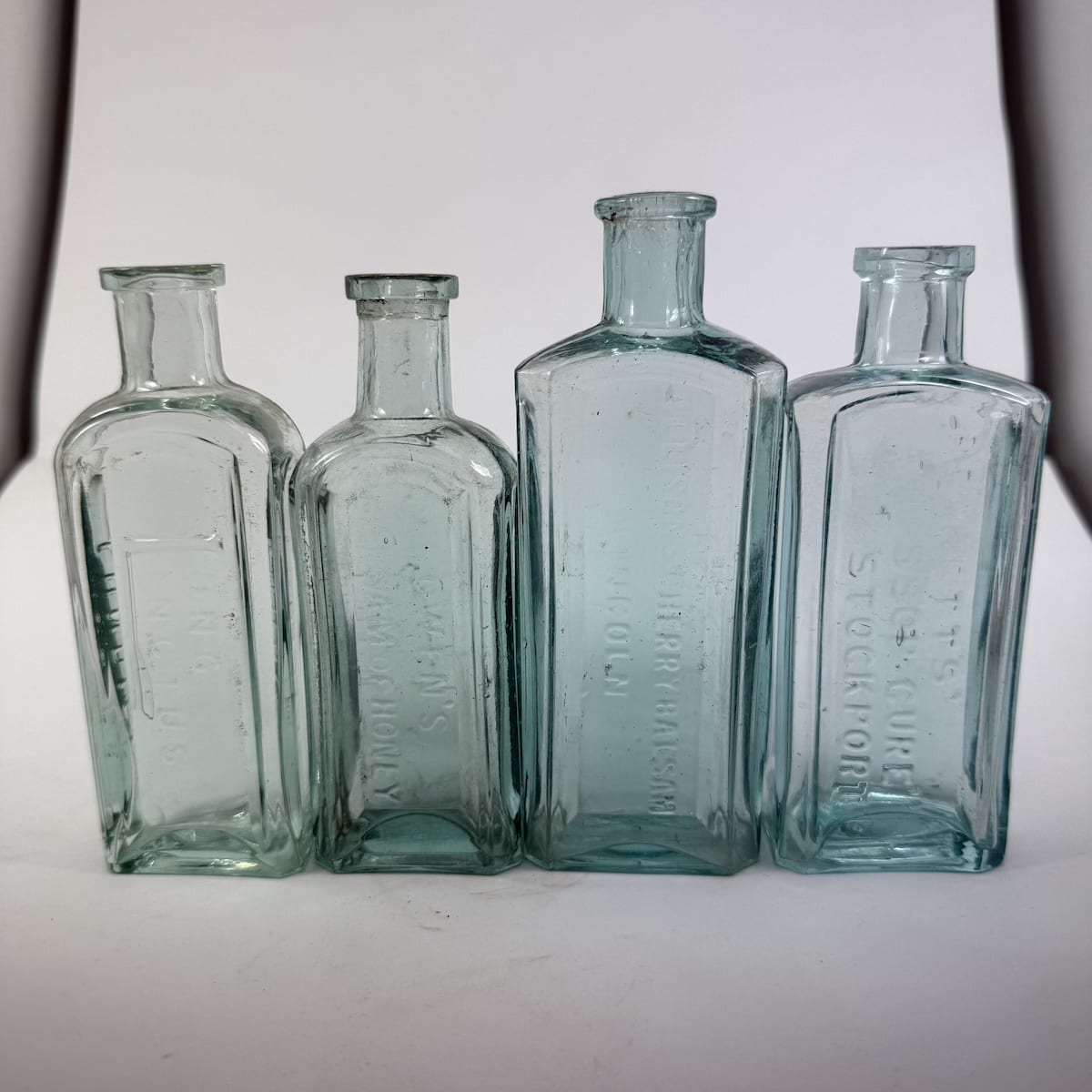 4 Cure Bottles: Allison's Cherry Balsam Lincoln; Bennett's Hyssop Cure Stockport; Lundies Lung Linctus; Owens Balsam of Honey. (UK)