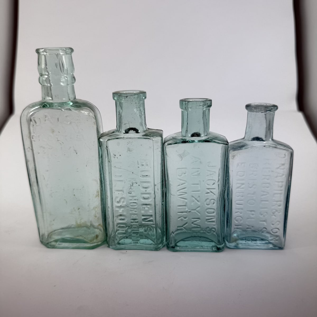 4 Cure Bottles: Day's Oil of the Night; Budden's Balsam of Horehound; Jackson's Antizyme; Napier & Son Herbalists Edinburgh. (UK)
