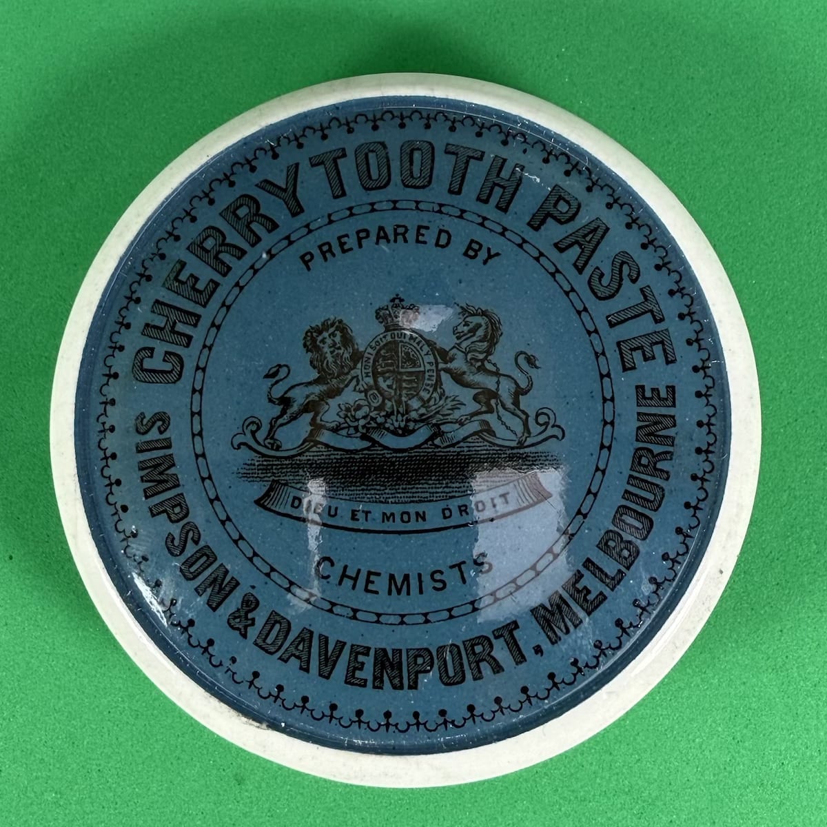 Pot Lid. Simpson & Davenport, Melbourne. Coat of Arms. Cherry Tooth Paste. Blue & Black. With base. 79 mm diameter. (Victoria)