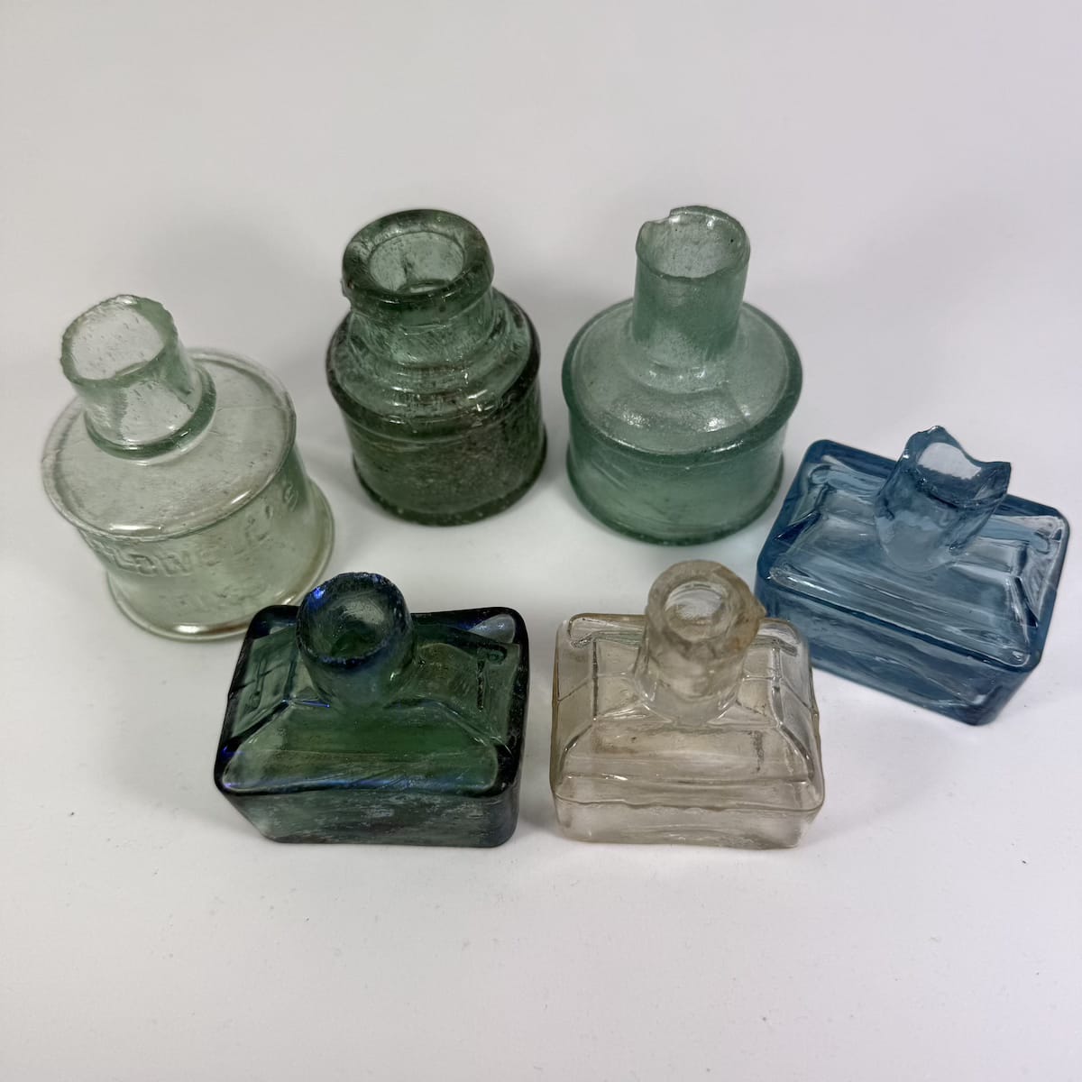 6 Glass Inks: 3 Boat shapes; 3 Round ones. Caldwells. Ice Blue. Clear Glass with ground lip; etc.