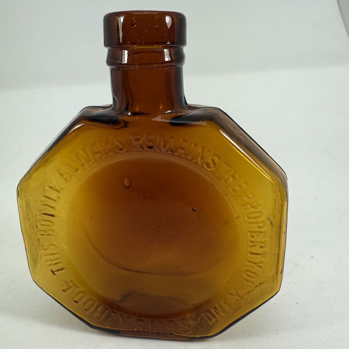 Brandy. Flask. Amber glass Toohey's Ltd Sydney. Octagonal shape. (New South Wales)