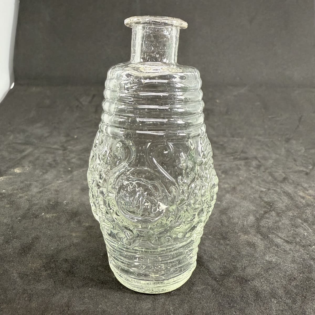 Cologne. Clear Flint Glass. Barrel shaped with Floral decoration around the middle. Monogram to one side. Sharp pontil scar.