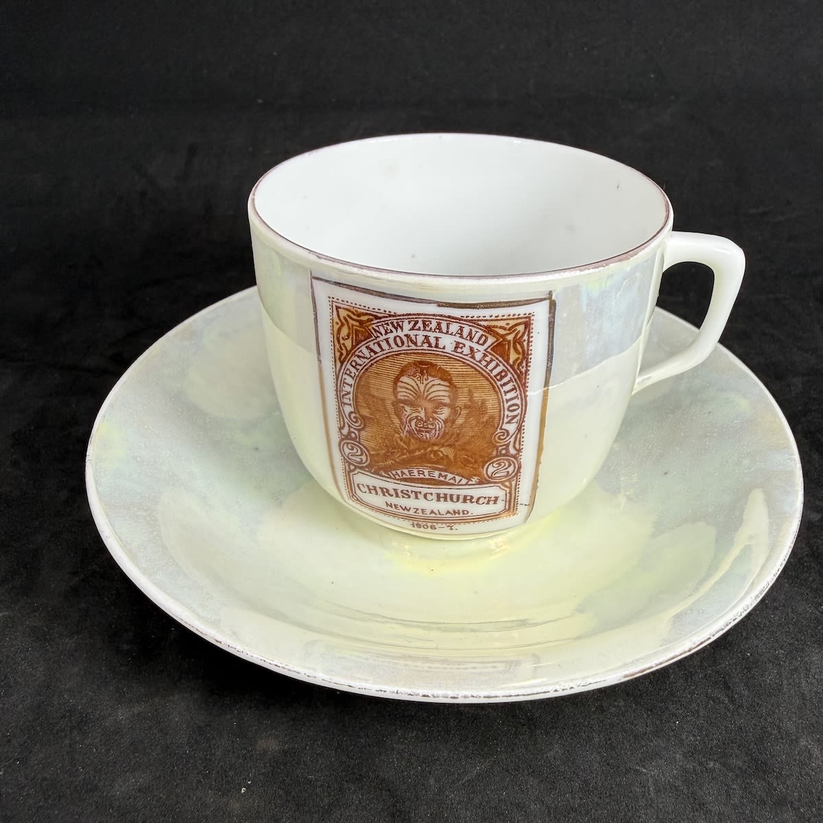 Lustreware Cup and Saucer. New Zealand International Exhibition 1906-7.