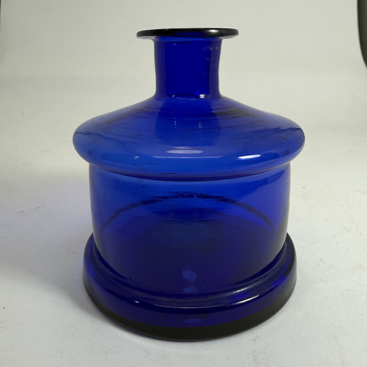 Ink. Large Cobalt Blue Cotton Reel shape. Thin lip. Pontil scar to base.