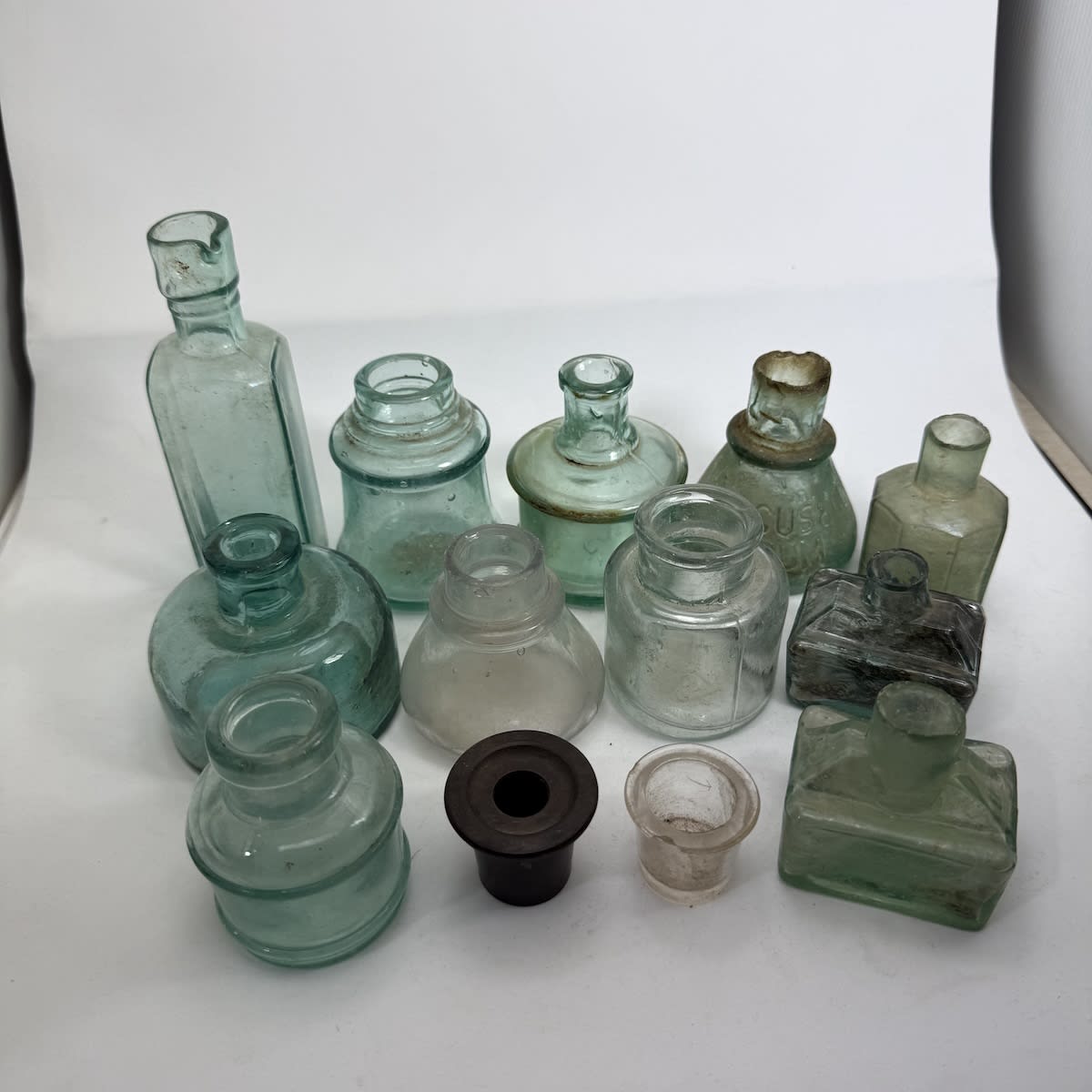 13 Inks & Inkwells. Glass Inks and Inkwells. One bakelite inkwell insert. Angus & Co. Gums.