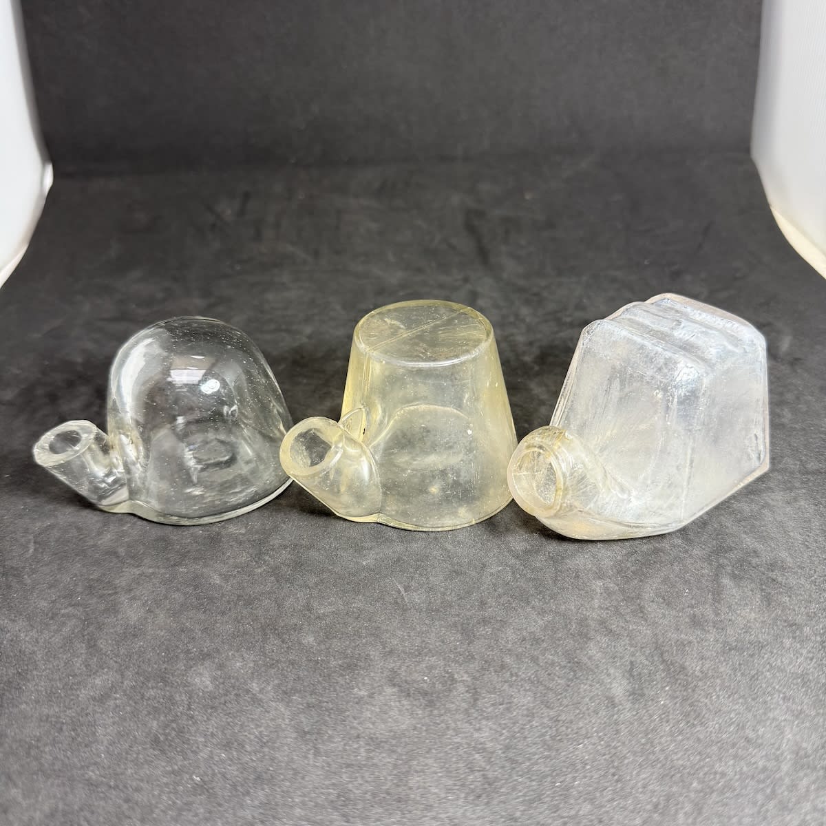 3 Glass Inks. Igloo type shapes. Plain dome top; Plain flat top; Square shape with pen rests on top, Stephens London with sunburst underneath.