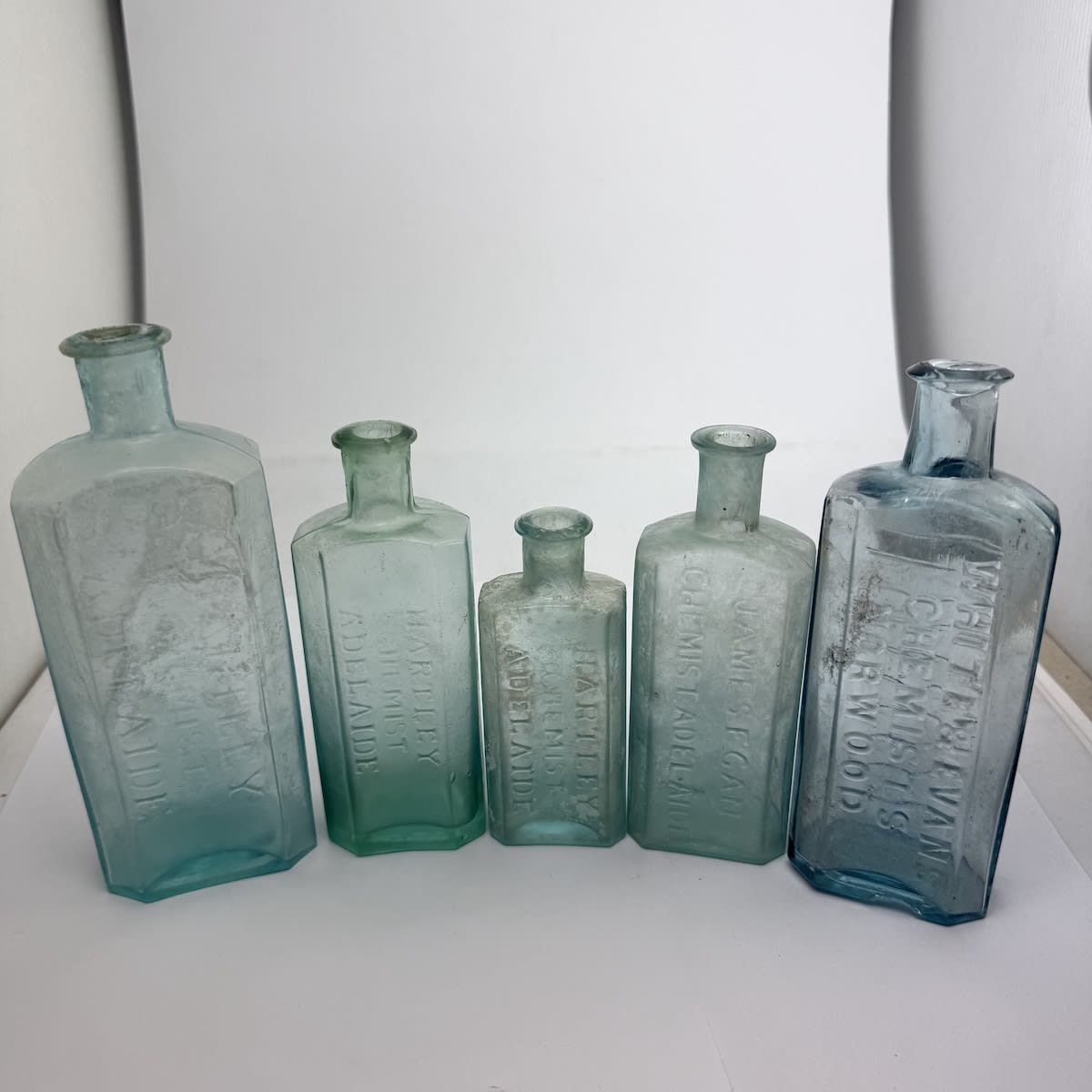 5 early Adelaide Chemists: 3 x different Hartley, Chemist (164, 135 & 108 mm); James Egan (132 mm); White & Evans Chemists, Norwood (154 mm). (South Australia)