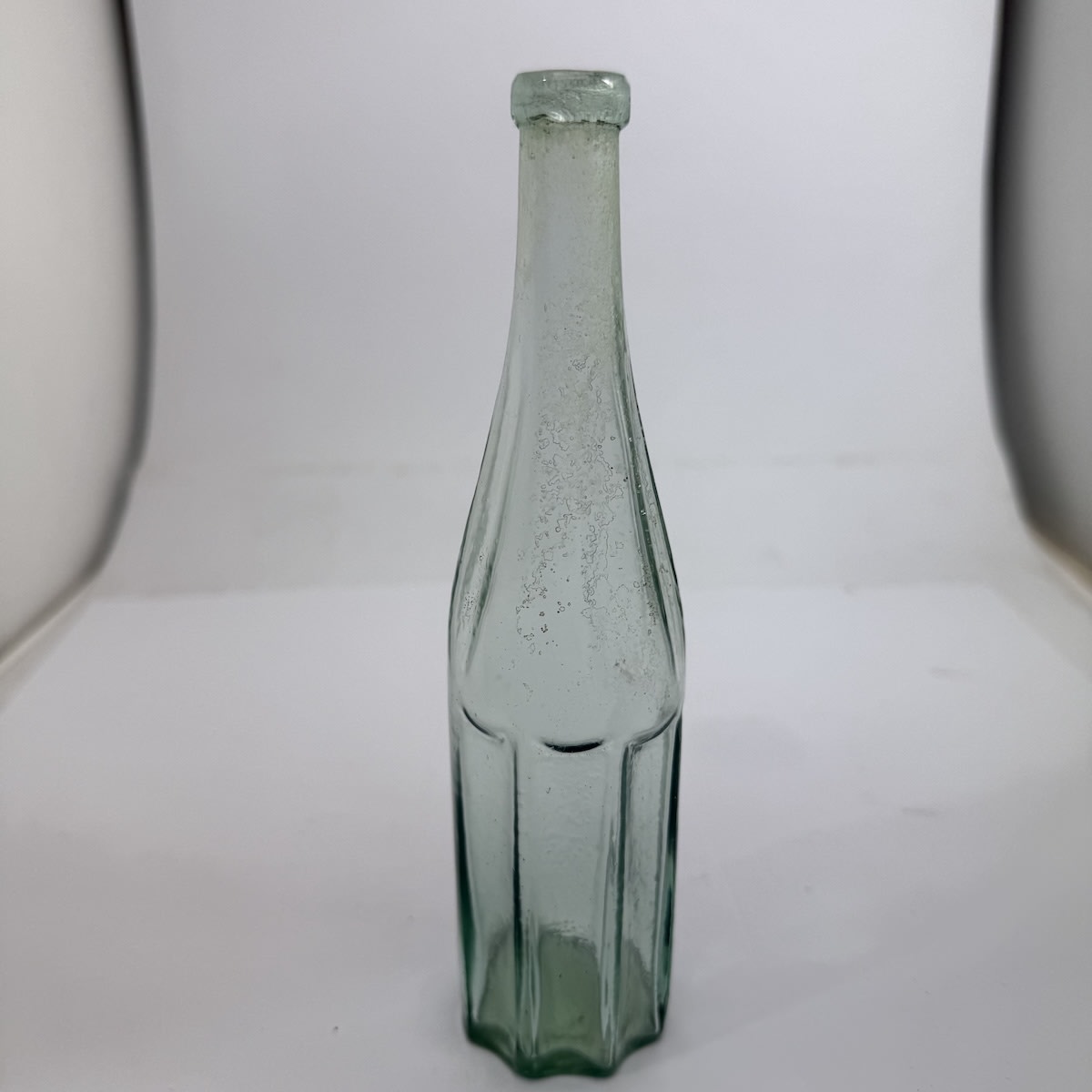 Sample sized Goldfields Salad Oil. Five Concave panels to body, label space. Six oval concave panels to neck/shoulder. Applied top. No base mark.