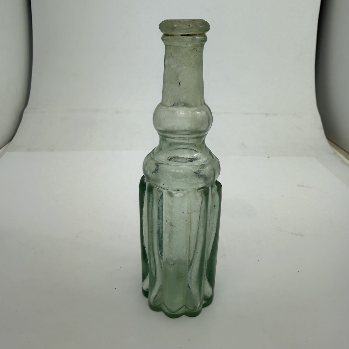 Sample sized Goldfields Salad Oil. Five big bulbous panels, round back. Very pronounced rings and convex middle to the neck and shoulder. Applied top. No base mark.