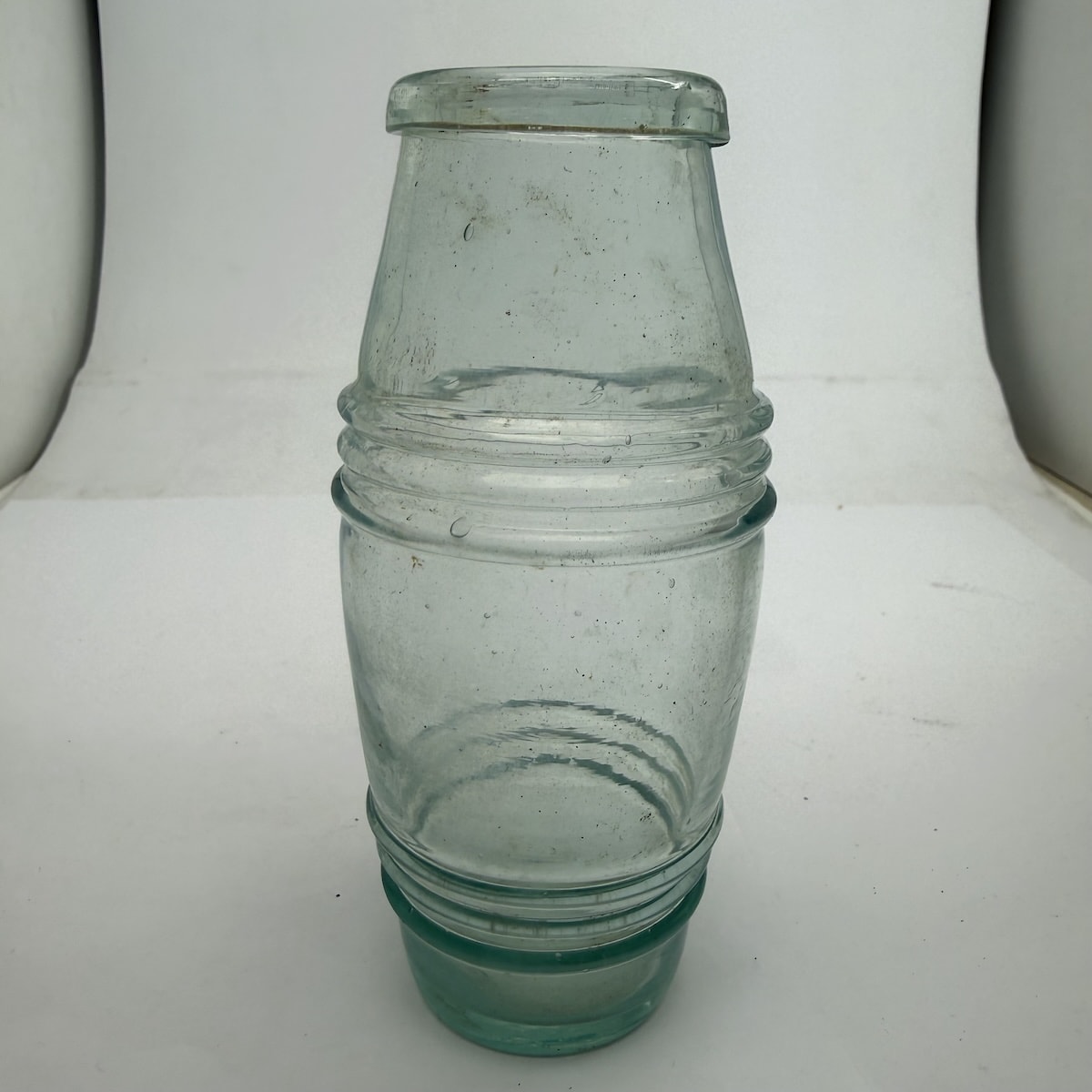 Goldfields Mustard Barrel. Aqua. Three rings to upper and lower body. Applied top. Pontil scar to base.