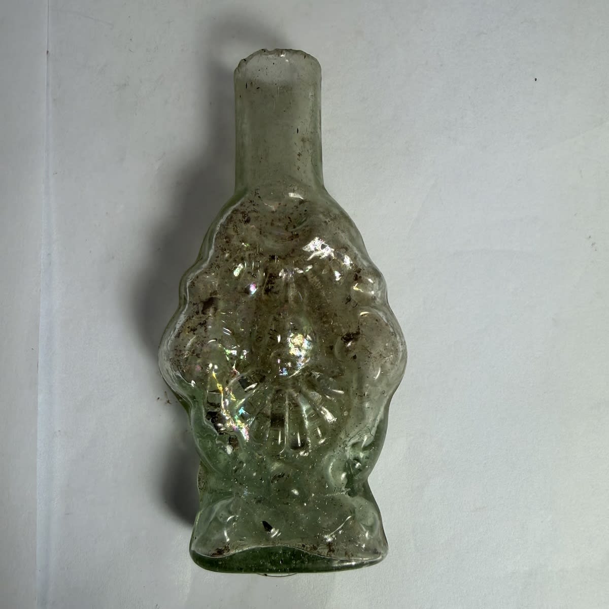 Cologne/Sherbert or similar. Shear lip. Figural of Indian or Maori Chief with fancy pattern. Doesn't stand up because the seam across the base has left an extra curved piece of glass.