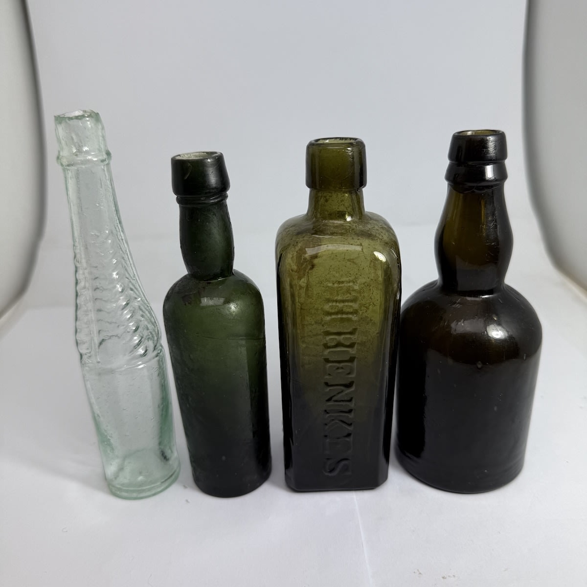 4 Samples: Salad Oil shape with Herringbone pattern to neck; Small green Whisky or similar. B to base; J. H. Henkes Schnapps; Fat squat whisky.