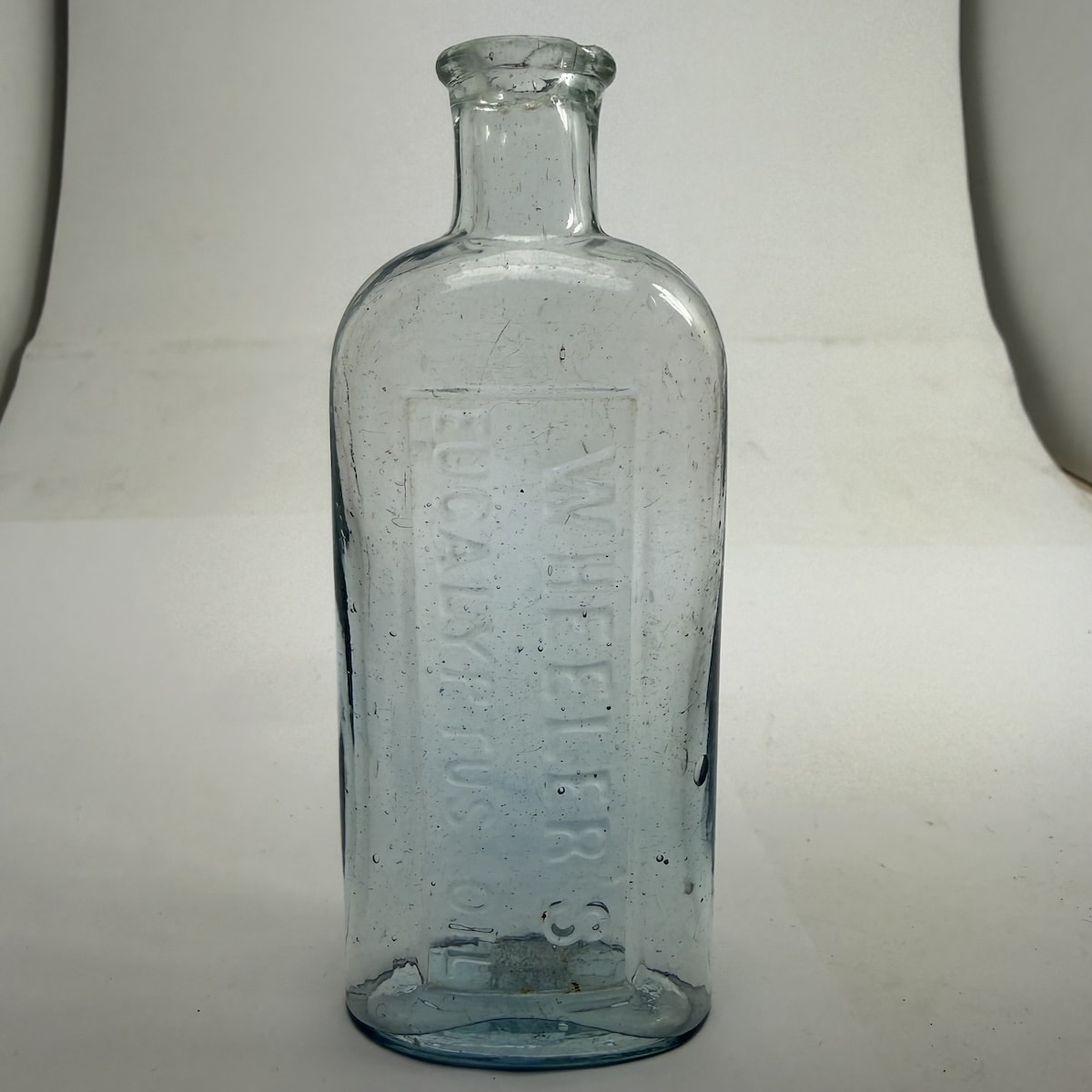 Eucalyptus Oil. Wheeler's Eucalyptus Oil. Pale Ice Blue. M base mark. (Blackwood, Victoria)