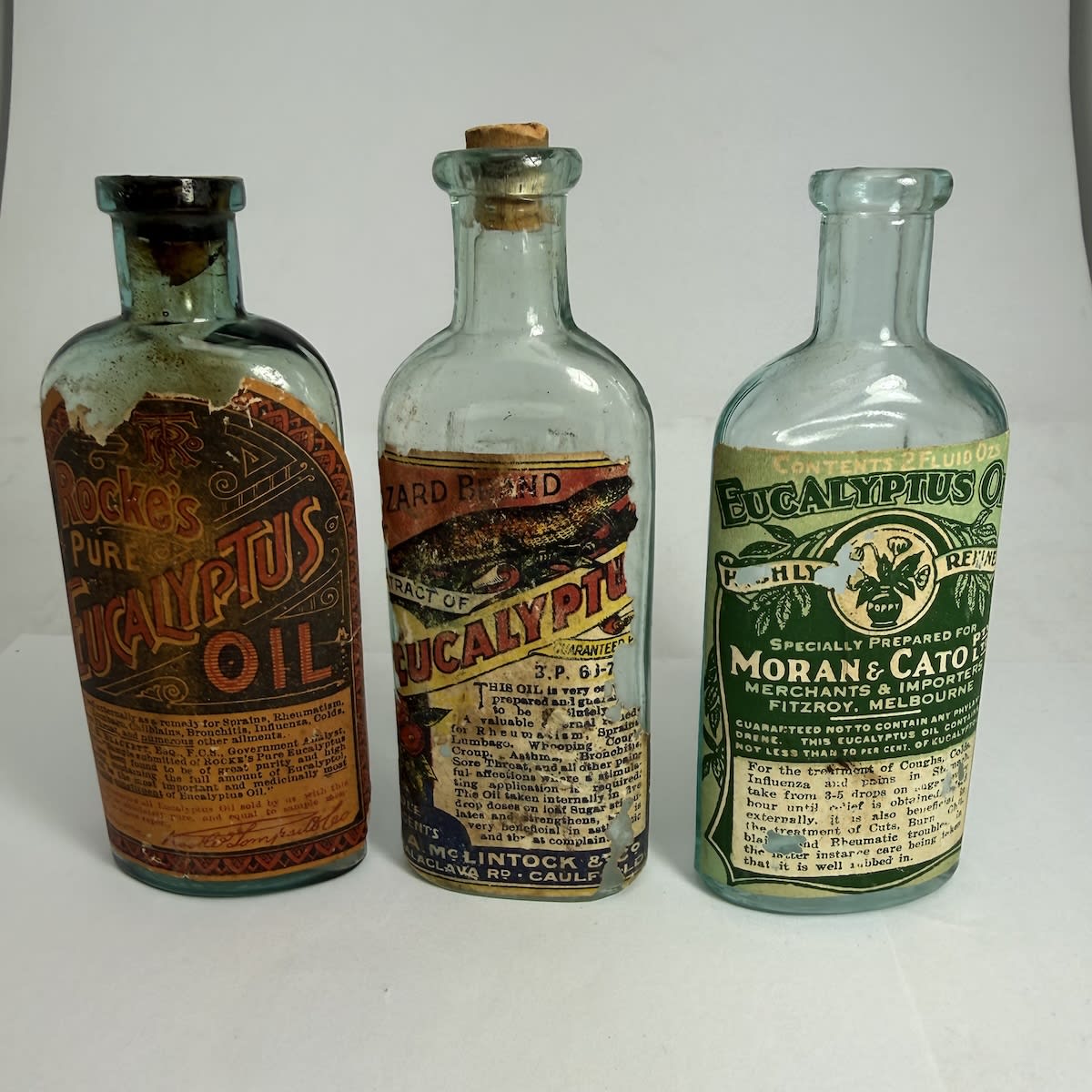 3 Labelled Melbourne Eucalyptus Bottles: Rocke's Pure Eucalyptus, Rocke Tompsitt & Co; Lizard Brand Eucalyptus, A. McLintock & Co Caulfield; Moran & Cato Pty Ltd, Fitzroy. (Victoria)