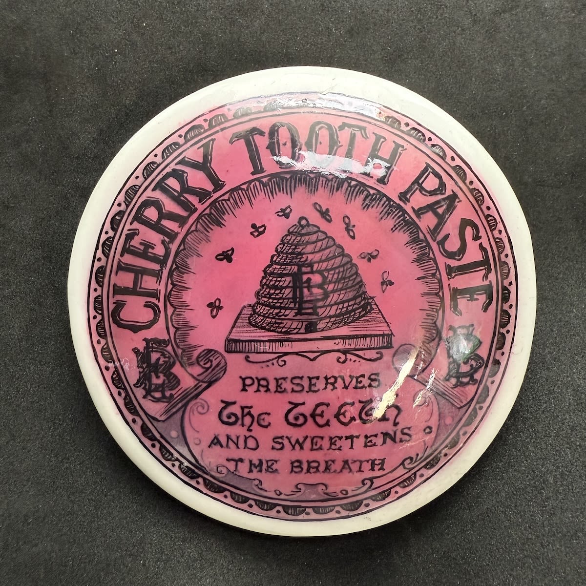 Pot Lid. Elliott Bros Cherry Tooth Paste. EB Monogram on Beehive. Pink & Black. (Sydney & Brisbane, New South Wales & Queensland)