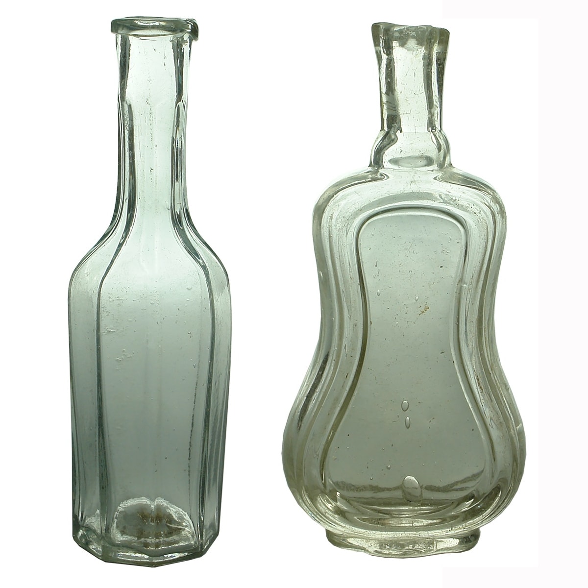 2 Goldfields era Flint glass bottles. Pontil scarred bases. Octagonal and Violin or Keyhole shapes.