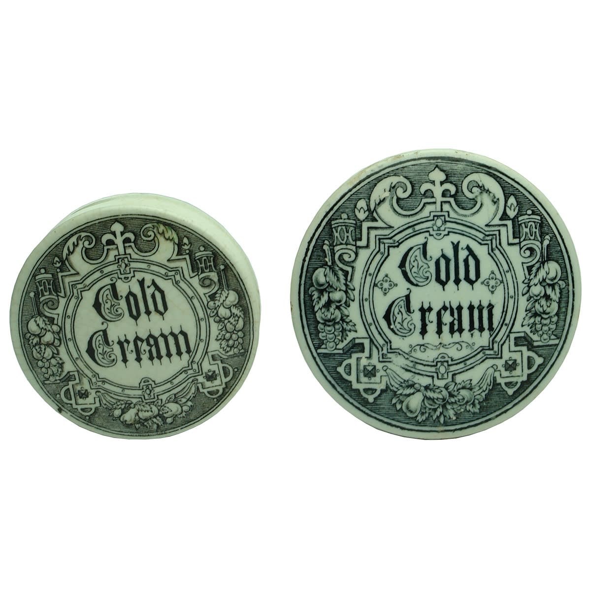 2 Cold Cream Pot Lids. Larger and smaller sizes with Gothic type patterns.