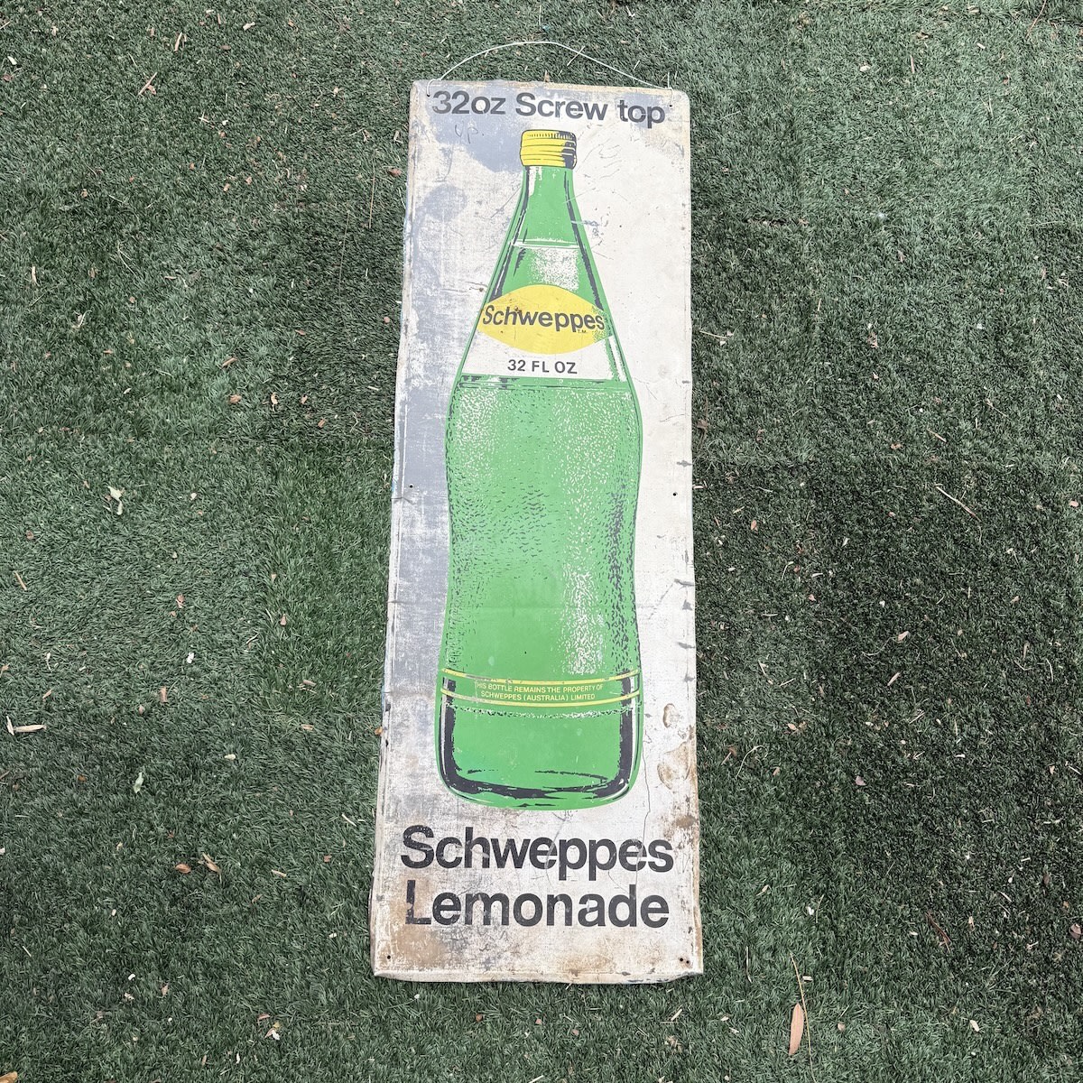 Printed Sign. Schweppes 32 oz Screw top. Bottle Pictorial. Schweppes Lemonade. 1370 x 455 mm.  (Too big for Australia Post so other arrangements will have to be made by the buyer to arrange a courier or pick up).
