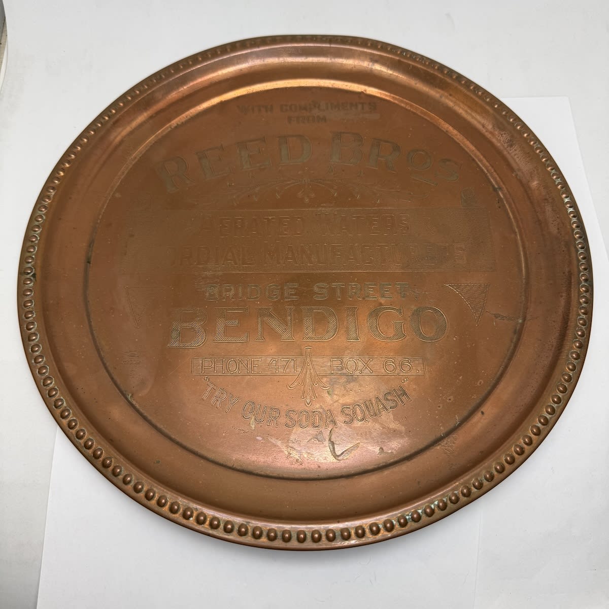 Advertising Serving Tray. Reed Bros., Aerated Waters & Cordial Manufacturers, Bridge Street, Bendigo. Try our Soda Squash. Copper plated. (Victoria)