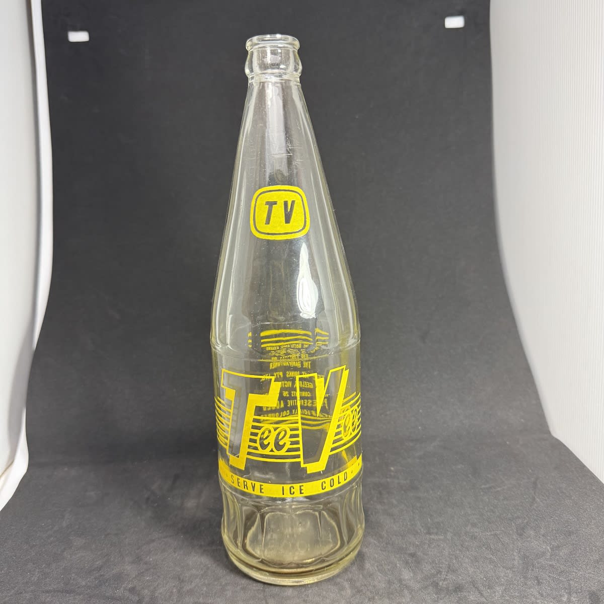 Ceramic Label Crown Seal. Tee Vee Drinks, Geelong. Yellow print. 26 oz with fancy fluted neck and base edge. (Victoria)
