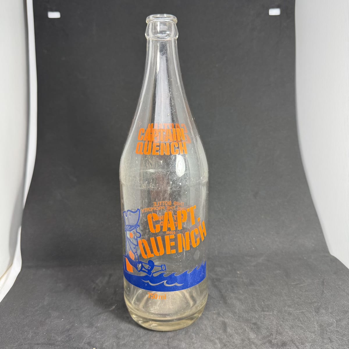 Ceramic Label Crown Seal. Captain Quench. Soft Drinks Pty Ltd. 750 ml. Orange & Blue Print. (New South Wales)