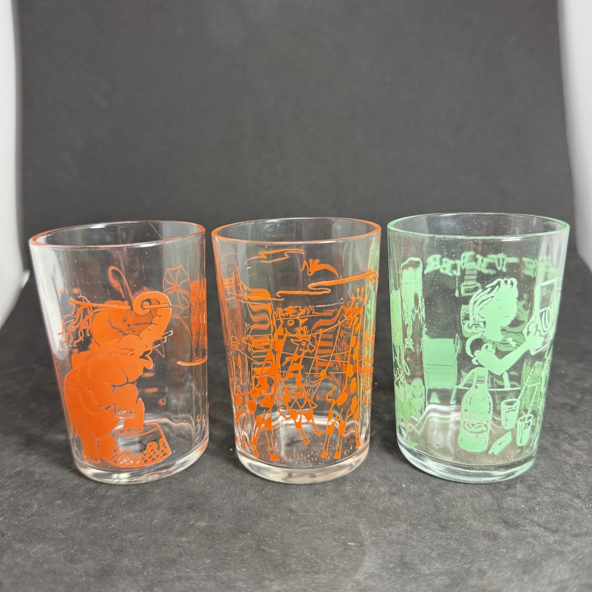3 Ceramic Label Glasses: Orange with Elephants Orange with Giraffes Green Party Tumbler, Bottle of Cottees Soft Drink, Fruit, Children etc.